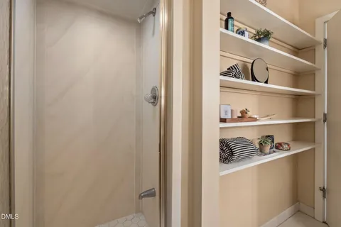 a large kitchen with stainless steel appliances wooden floor and a large window