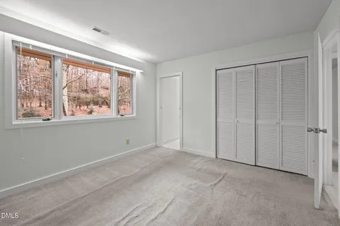 a view of staircase with railing and a painting on the wall