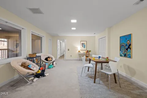 a view of a house with a yard garage and tree