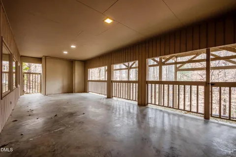 a view of a house with a small yard and wooden fence