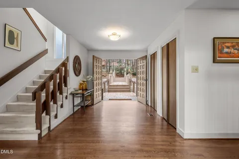 a view of a patio with table and chairs and potted plants