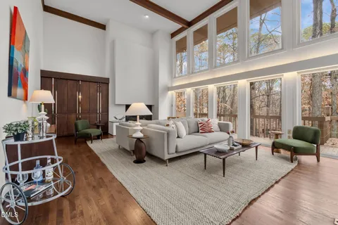 a living room with furniture and large windows