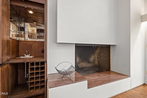 a living room with table chairs and cabinets