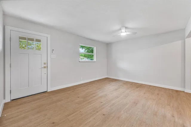 an empty room with windows and closet