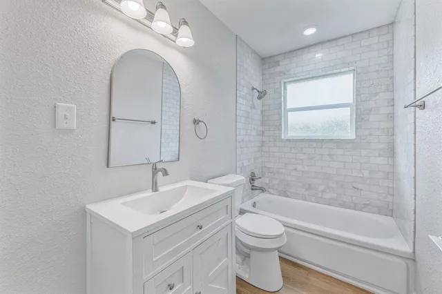 a bathroom with a sink a toilet and a bathtub