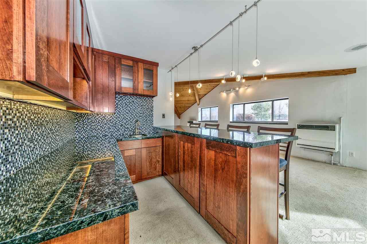 239 Theobald Reno, NV 89521 - Photo 14 of 23 a kitchen with stainless steel appliances granite countertop a sink and a stove