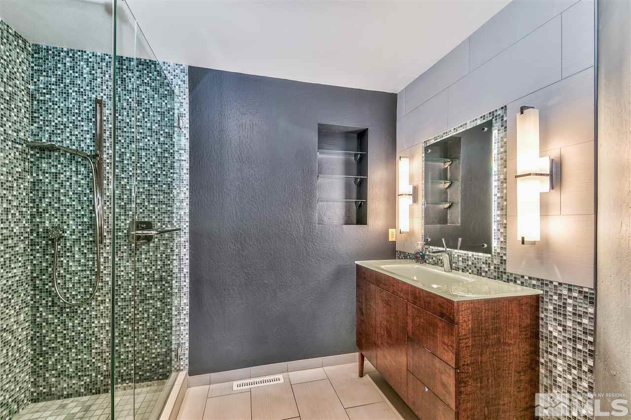 239 Theobald Reno, NV 89521 - Photo 17 of 23 a bathroom with a granite countertop sink a mirror and shower