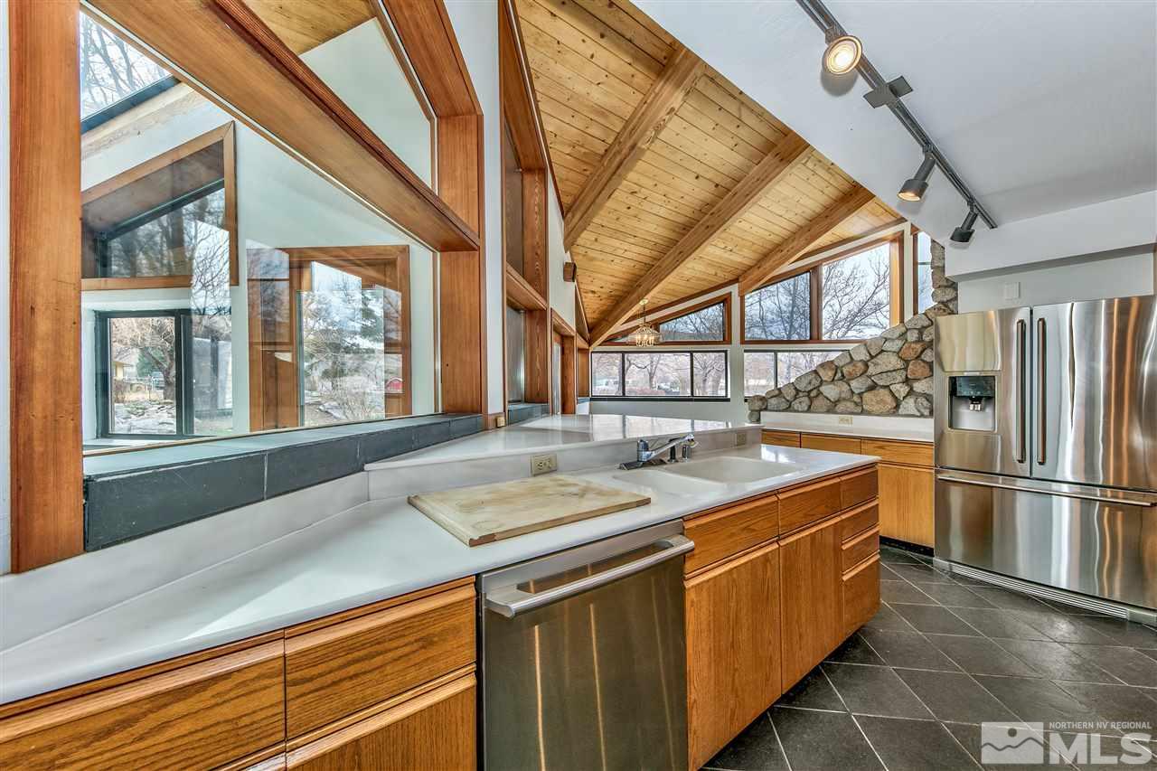239 Theobald Reno, NV 89521 - Photo 7 of 23 a kitchen with a sink and a refrigerator