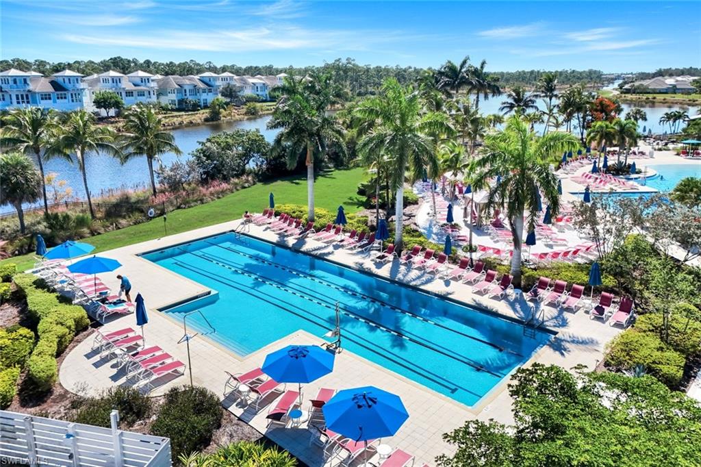 4905 Andros Drive Naples, FL 34113 - Photo 22 of 45 Community pool with a patio area, a residential view, and a lawn