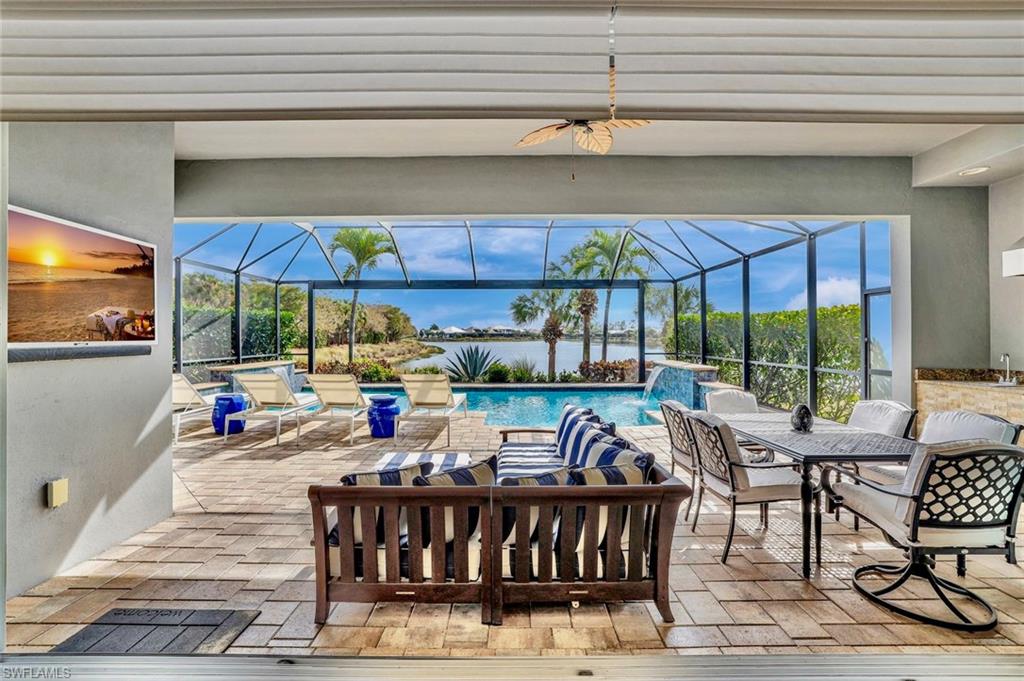 4905 Andros Drive Naples, FL 34113 - Photo 4 of 45 View of patio / terrace with a panaramic screenenclosure, outdoor kitchen and dining space