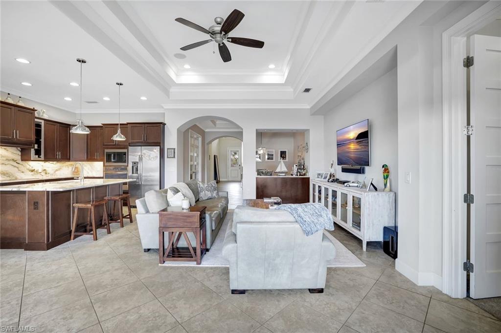4905 Andros Drive Naples, FL 34113 - Photo 42 of 45 Living area featuring arched walkways, crown molding,recessed lighting, and a ceiling fan