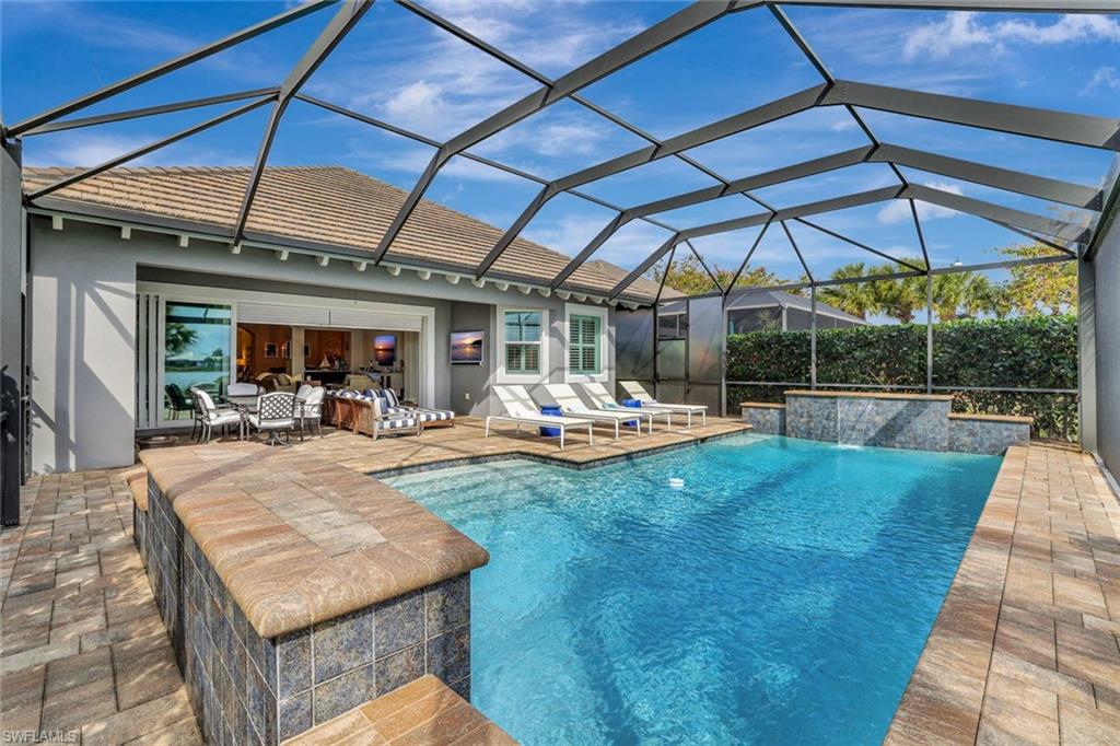 4905 Andros Drive Naples, FL 34113 - Photo 10 of 45 Swimming pool featuring two waterfalls and outdoor living space