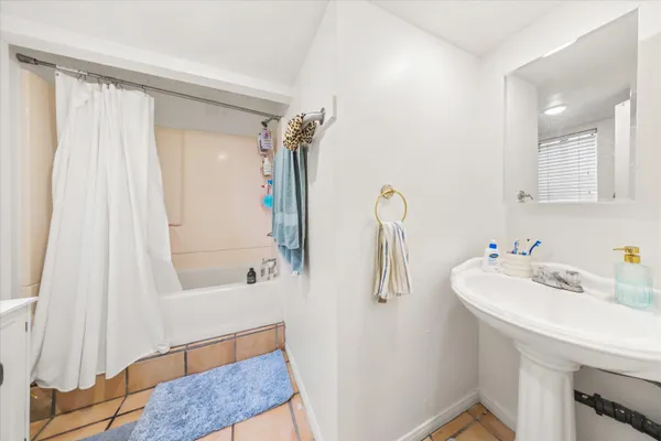 a bathroom with a sink a mirror and a bathtub