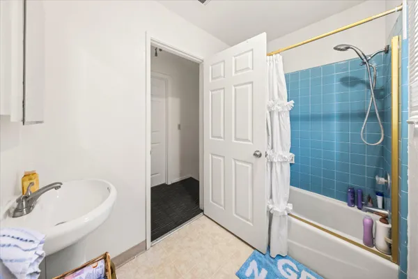 a bathroom with a bathtub and a shower