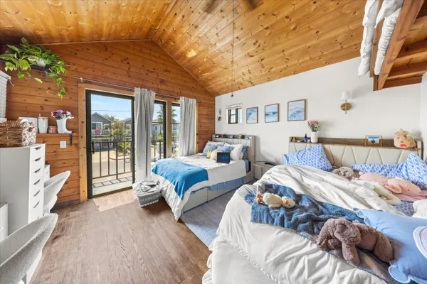 a bedroom with bed and glass door