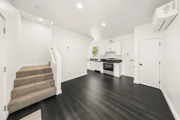 a view of kitchen with wooden floor and electronic appliances