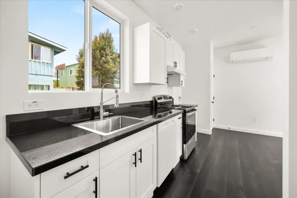a kitchen that has a sink and a stove