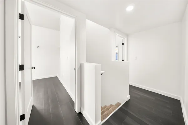 a view of a hallway with wooden floor