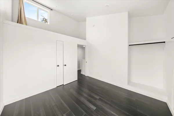a view of an empty room with wooden floor