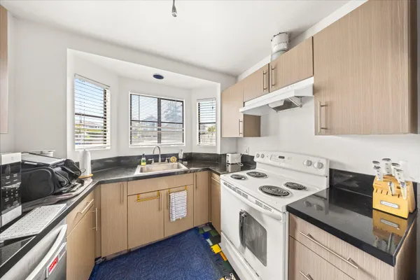 a kitchen with a sink stove and cabinets