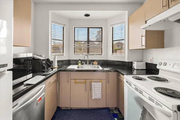 a kitchen with a sink stove and cabinets