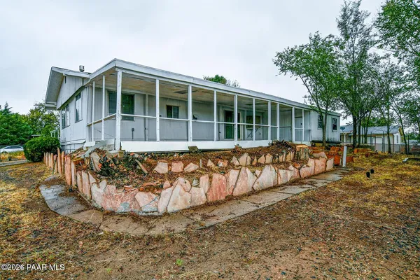 a kitchen with stainless steel appliances a refrigerator a sink and white cabinets