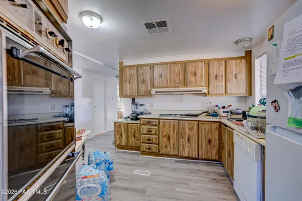 a view of a backyard with potted plants and large tree