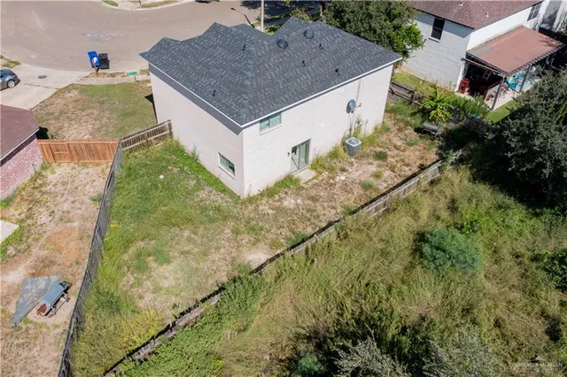 an aerial view of residential house with pool and yard
