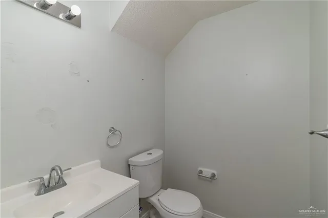 a white toilet sitting next to a bathroom sink