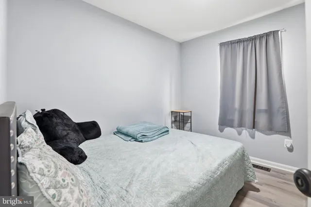 a bedroom with a bed and curtain