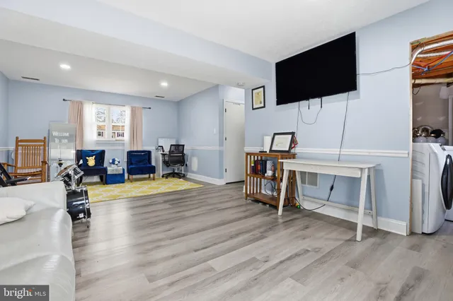 a view of a livingroom with furniture and a flat screen tv