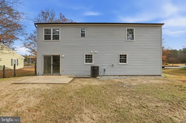 a view of a brick house with a yard