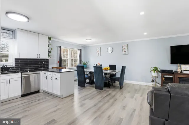 a kitchen with sink cabinets and wooden floor