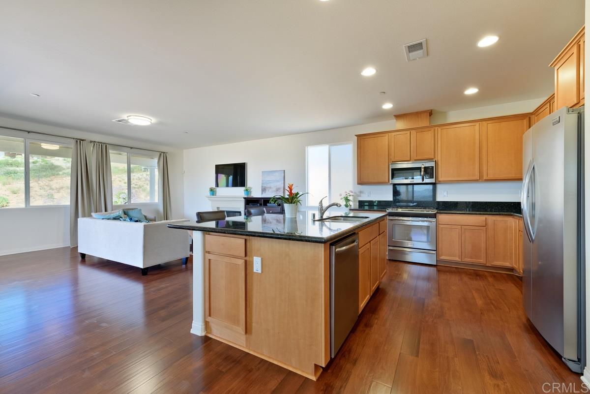 23005 Stokes Road Ramona, CA 92065 - Photo 8 of 25 Open kitchen with stainless steel appliances.