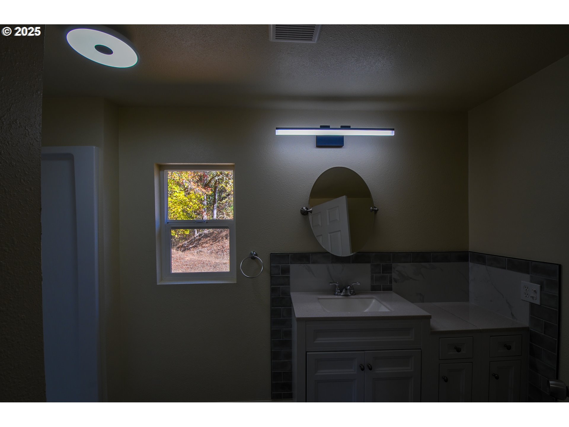 2193 Canyonville-Riddle Road Riddle, OR 97469 - Photo 23 of 25 a bathroom with a sink and a mirror