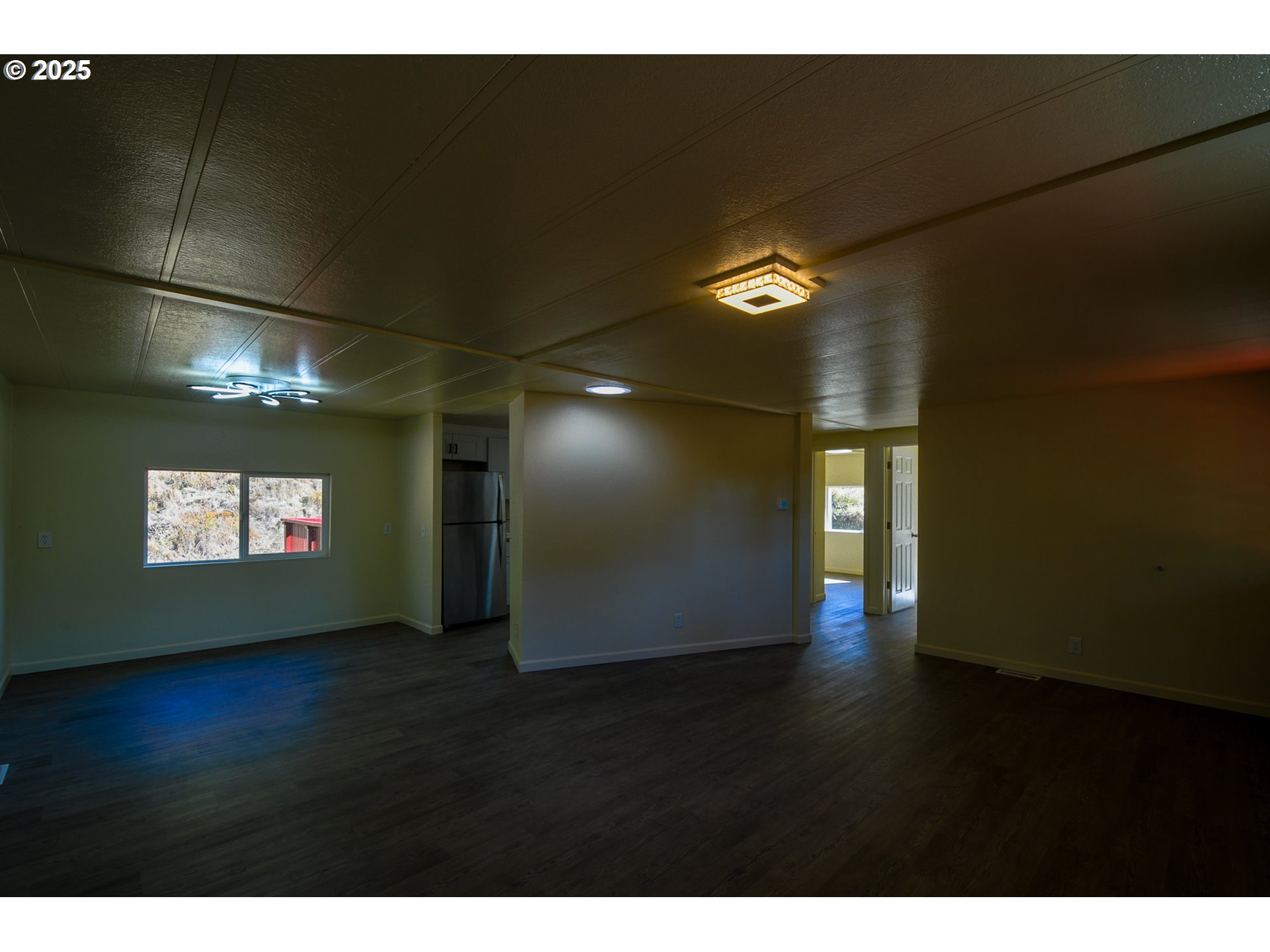 2193 Canyonville-Riddle Road Riddle, OR 97469 - Photo 8 of 25 a view of an empty room with wooden floor and windows