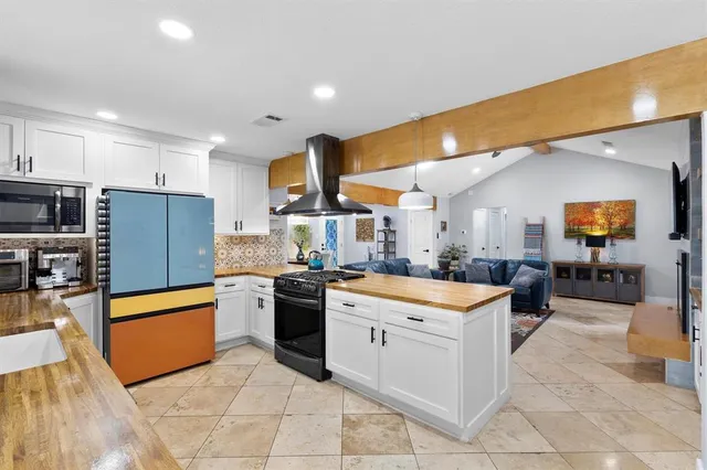 a kitchen with stainless steel appliances granite countertop a sink counter space and cabinets