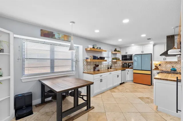 a kitchen with stainless steel appliances granite countertop a stove and a refrigerator