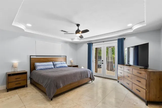 a bedroom with a bed and a flat screen tv