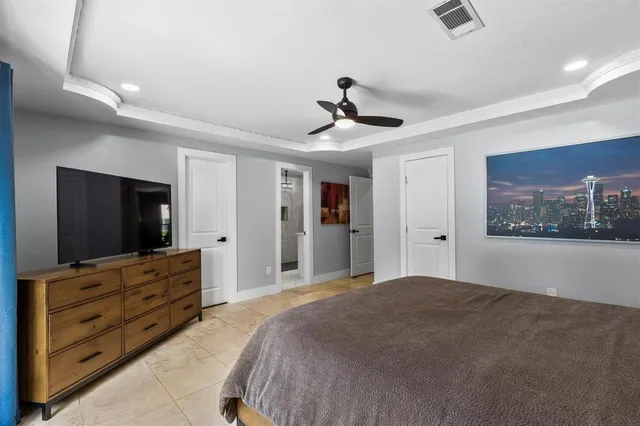 a bedroom with a bed and a flat screen tv