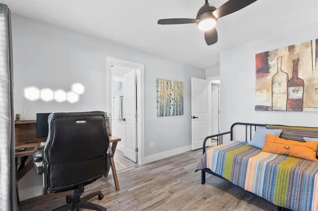 a bedroom with a bed and wooden floor
