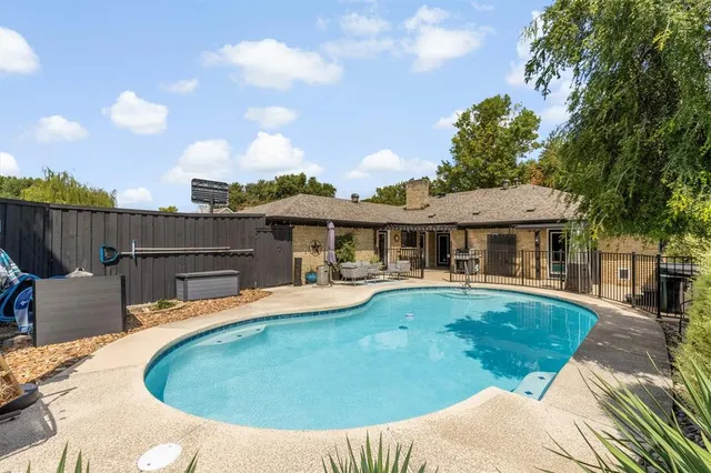a view of a house with pool yard and furniture