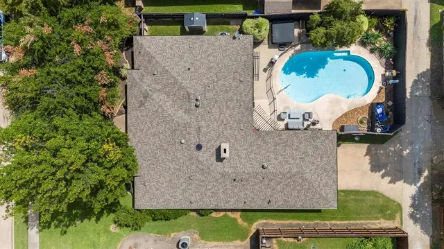 an aerial view of a house with a swimming pool