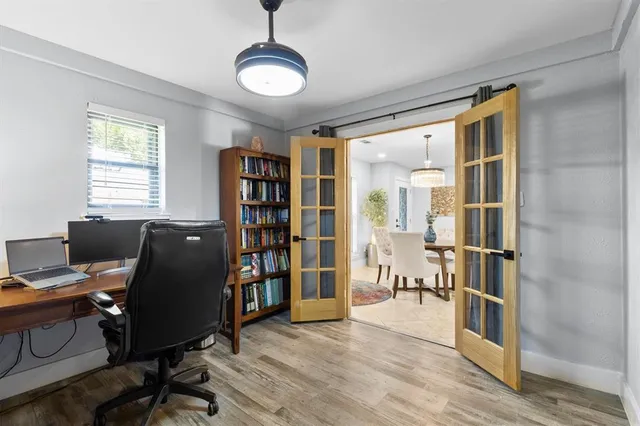 a view of a workspace with furniture and a window