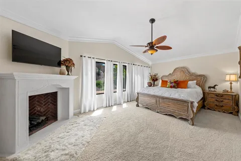a bedroom with a bed and a fireplace