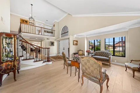 a living room with furniture a wooden floor and a chandelier