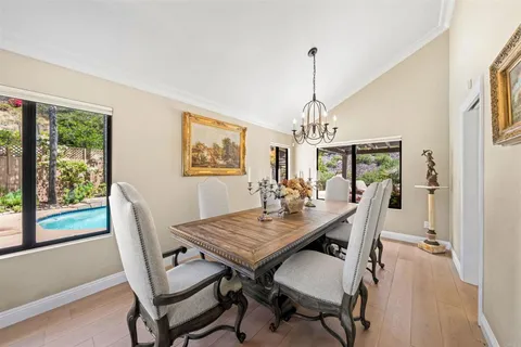 a kitchen with a sink cabinets and dining table chair