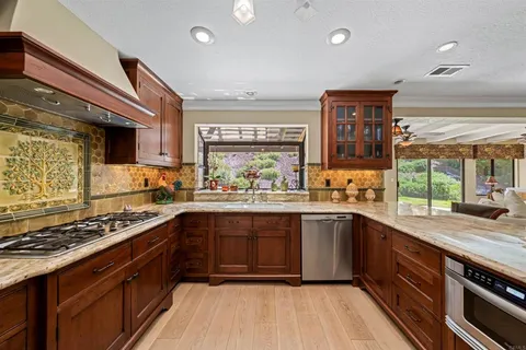 a kitchen with granite countertop stainless steel appliances and counter space