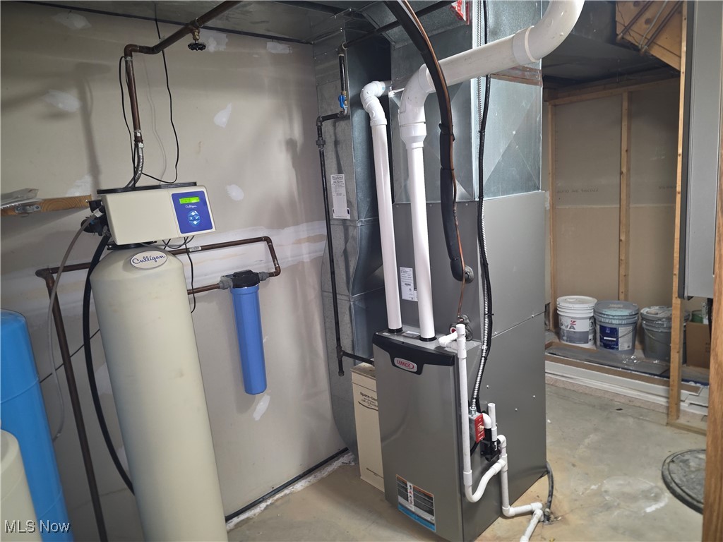 2291 Armstrong Road Wooster, OH 44691 - Photo 20 of 23 Utility room with heating unit, water softener, and tankless water heater
