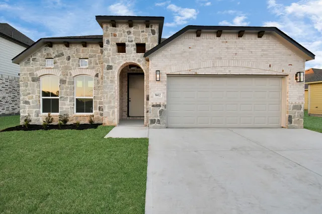 a view of a white house with yard